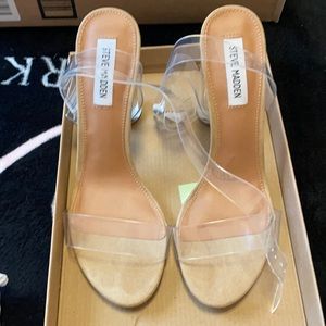 Nude Steve Madden heels with clear heel.